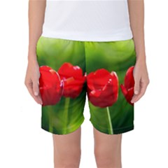 Three Red Tulips, Green Background Women s Basketball Shorts by FunnyCow