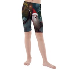 A Santa Claus Standing In Front Of A Dragon Kids  Mid Length Swim Shorts by bobilostore