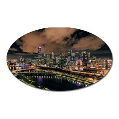 Cityscape Night Buildings Oval Magnet by Simbadda